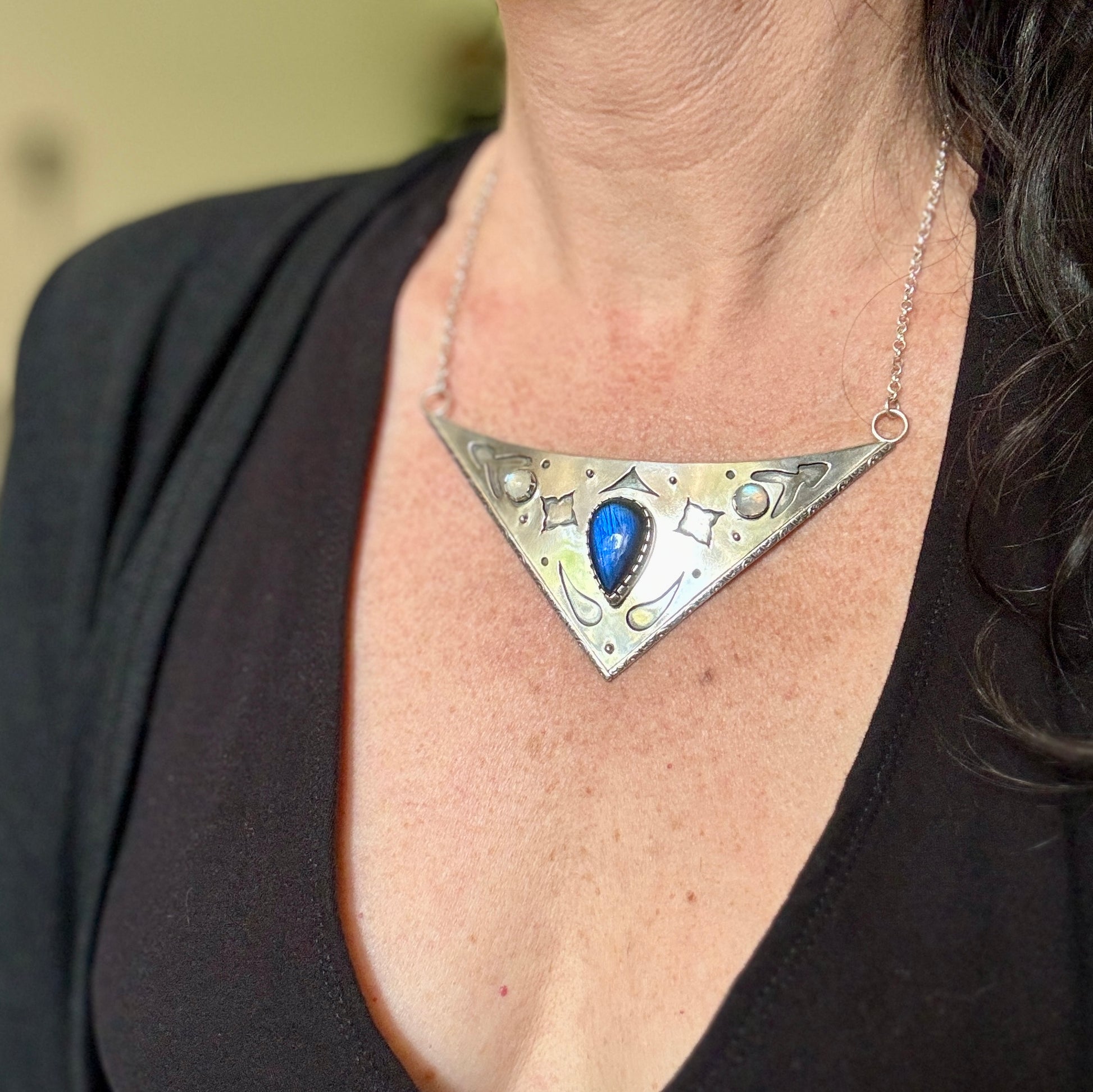 photo wearing an ornate collar necklace with labradorite and moonstone