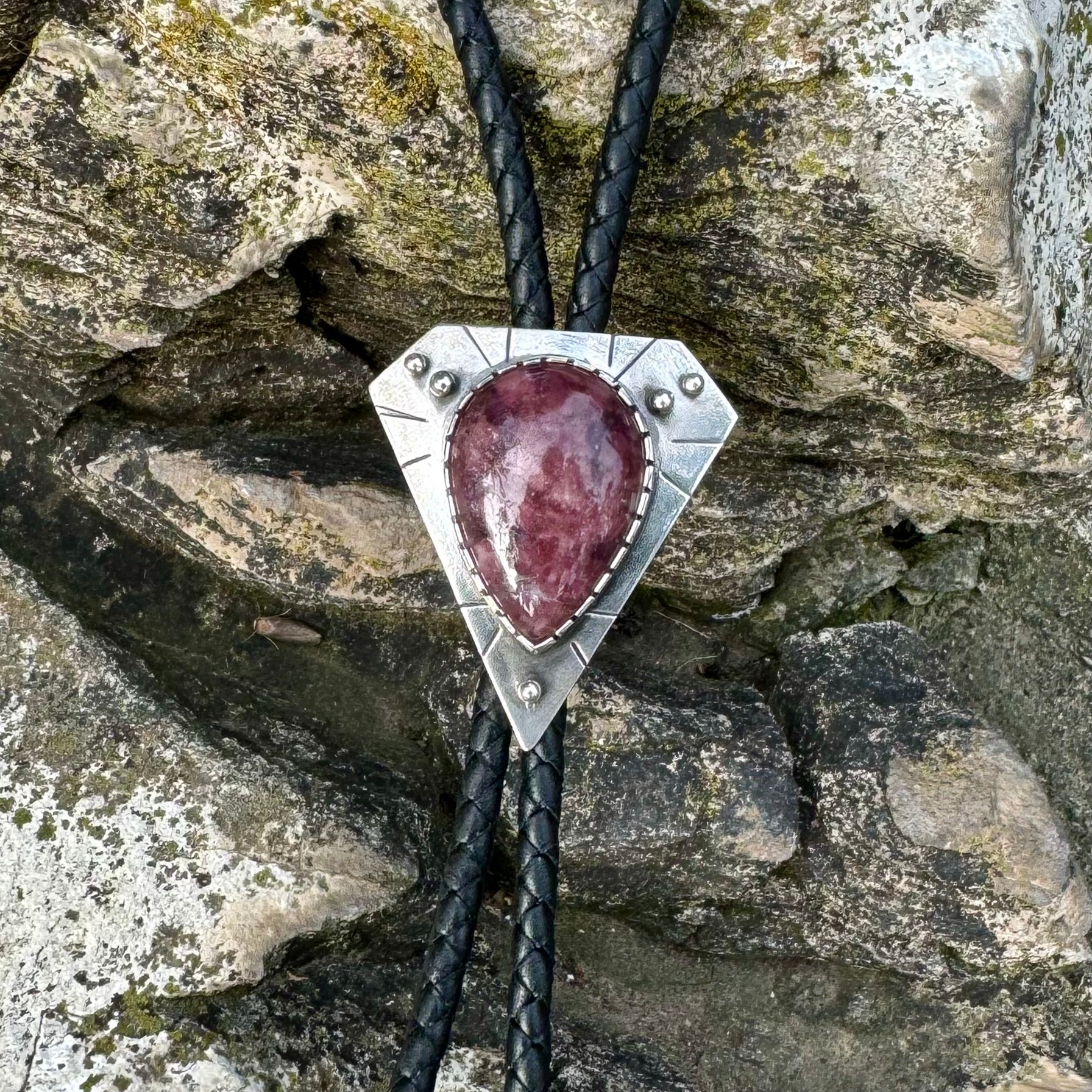 photo of silver lepidolite bolo tie with line designs and spheres