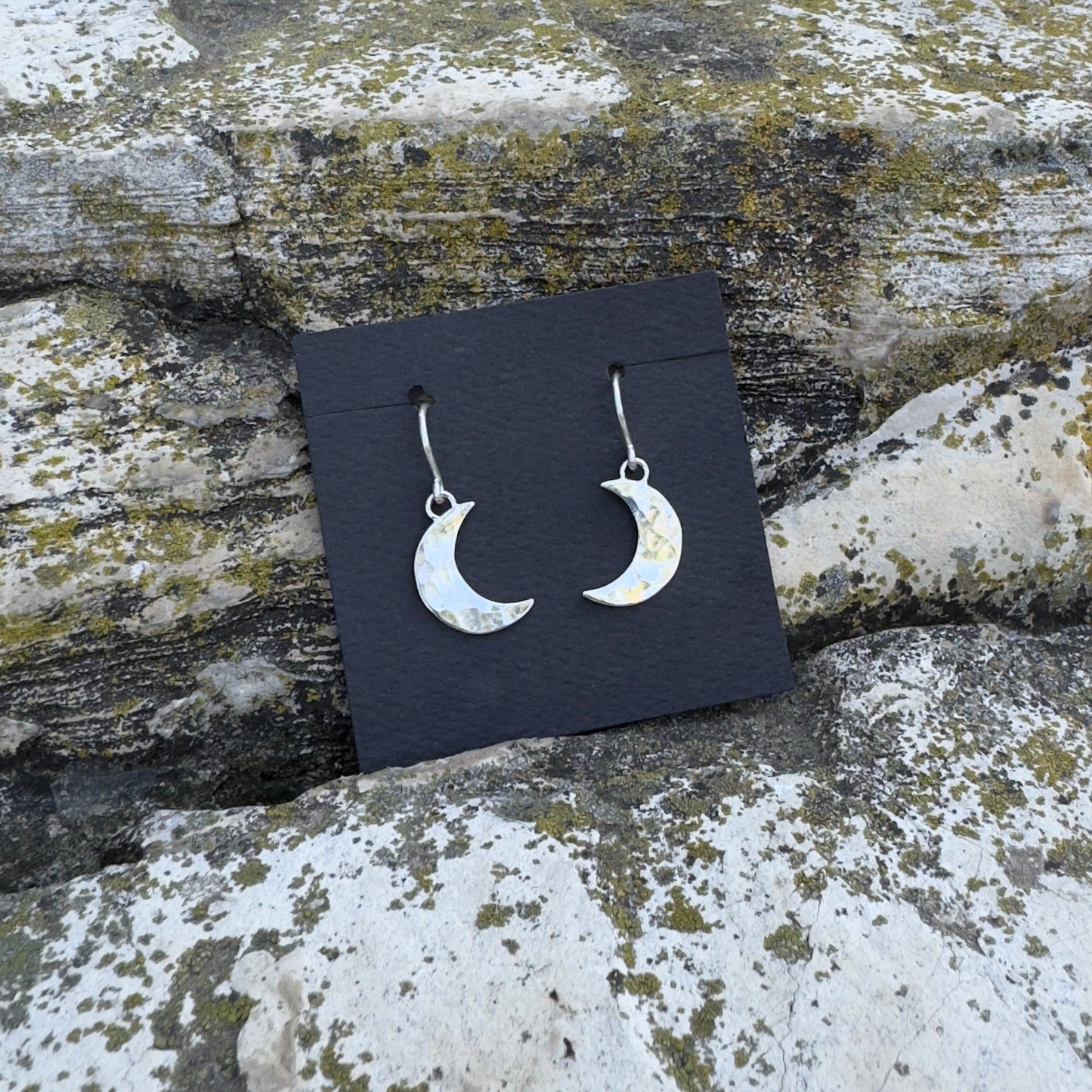 photo of a pair of silver hammered crescent moon earrings