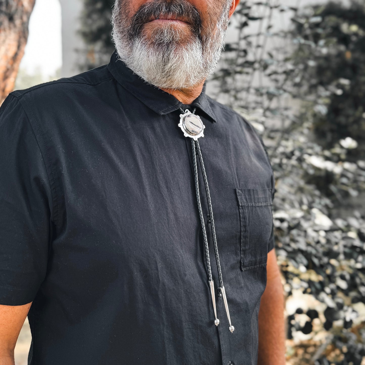 photo of a man's chest wearing unique silver sci-fi jasper bolo tie