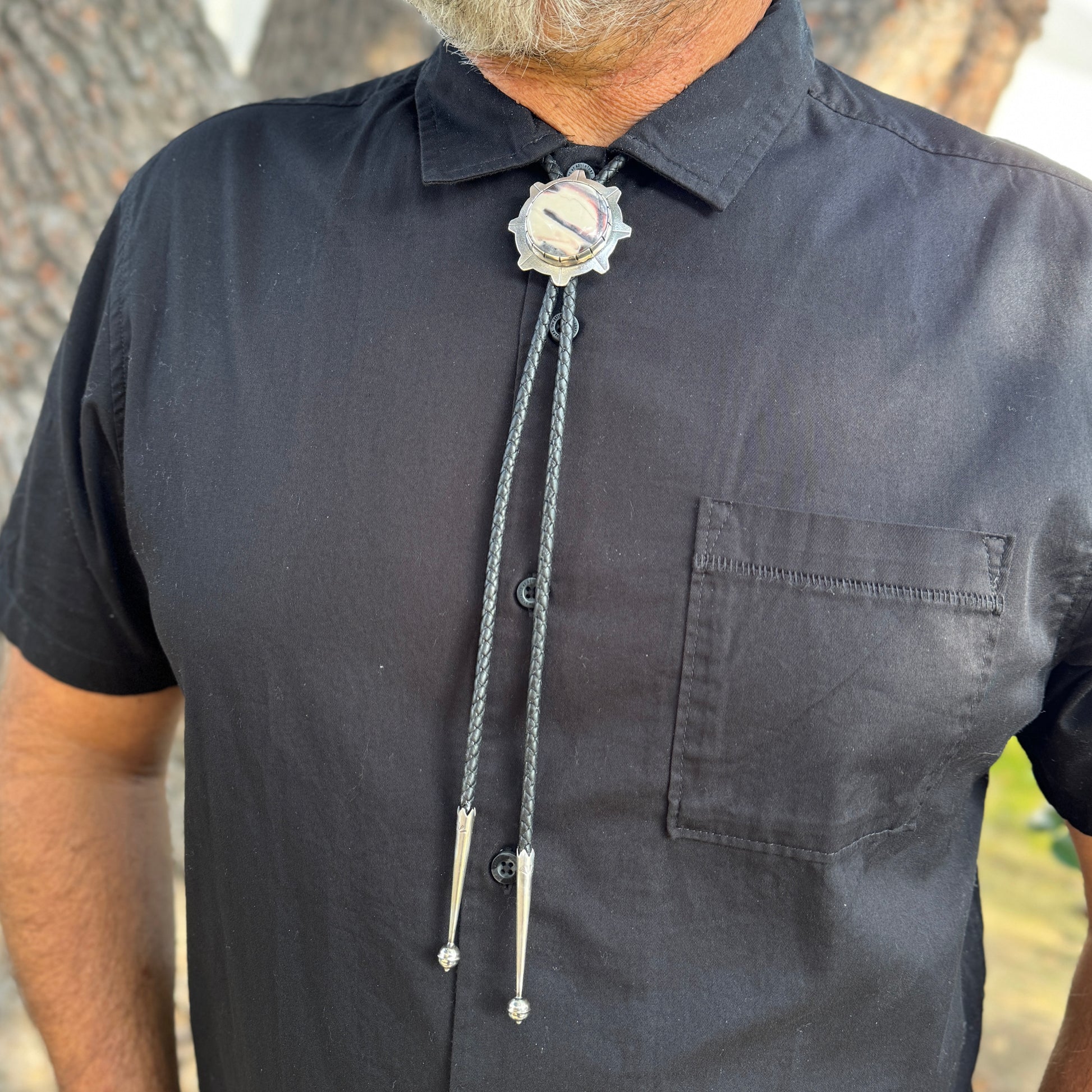 photo of a man's chest wearing unique silver sci-fi jasper bolo tie