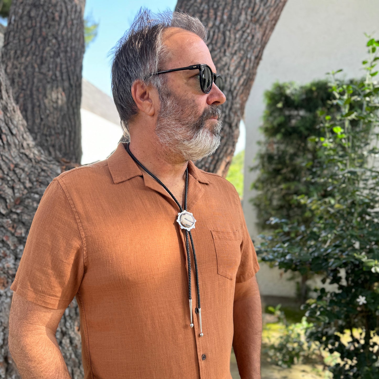 photo of a bearded man wearing unique silver sci-fi jasper bolo tie