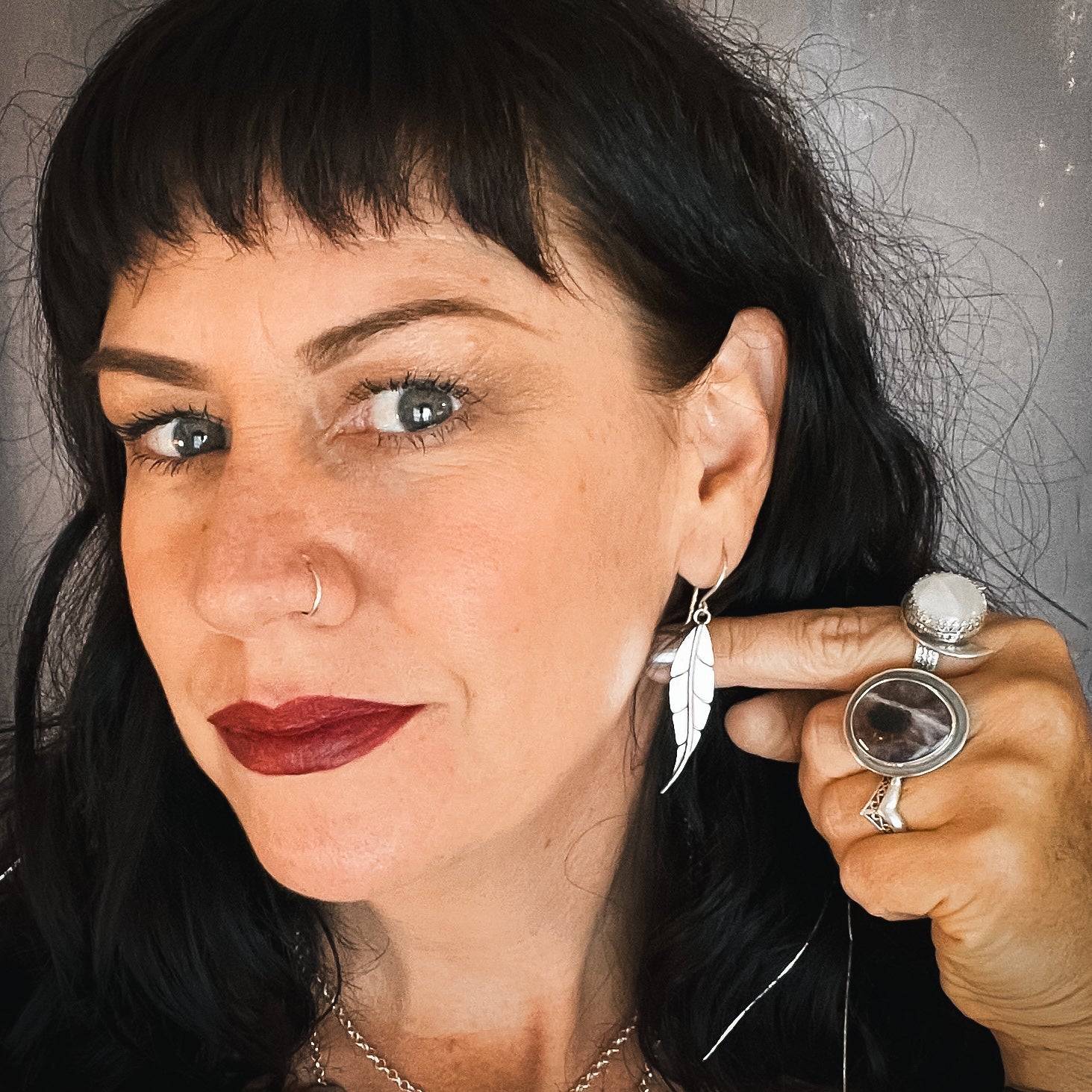 photo of a women wearing silver leaf earrings