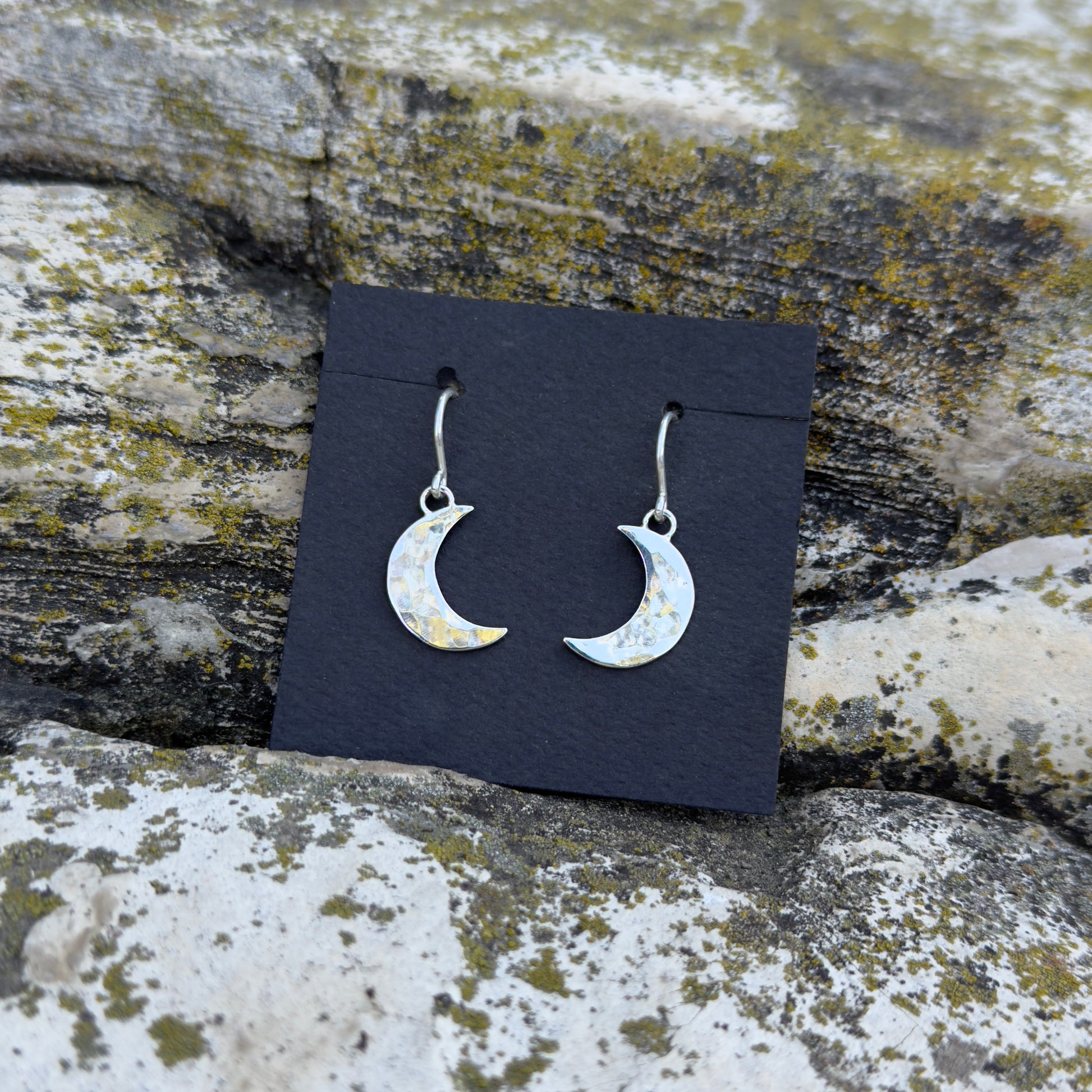 photo of a pair of silver hammered crescent moon earrings