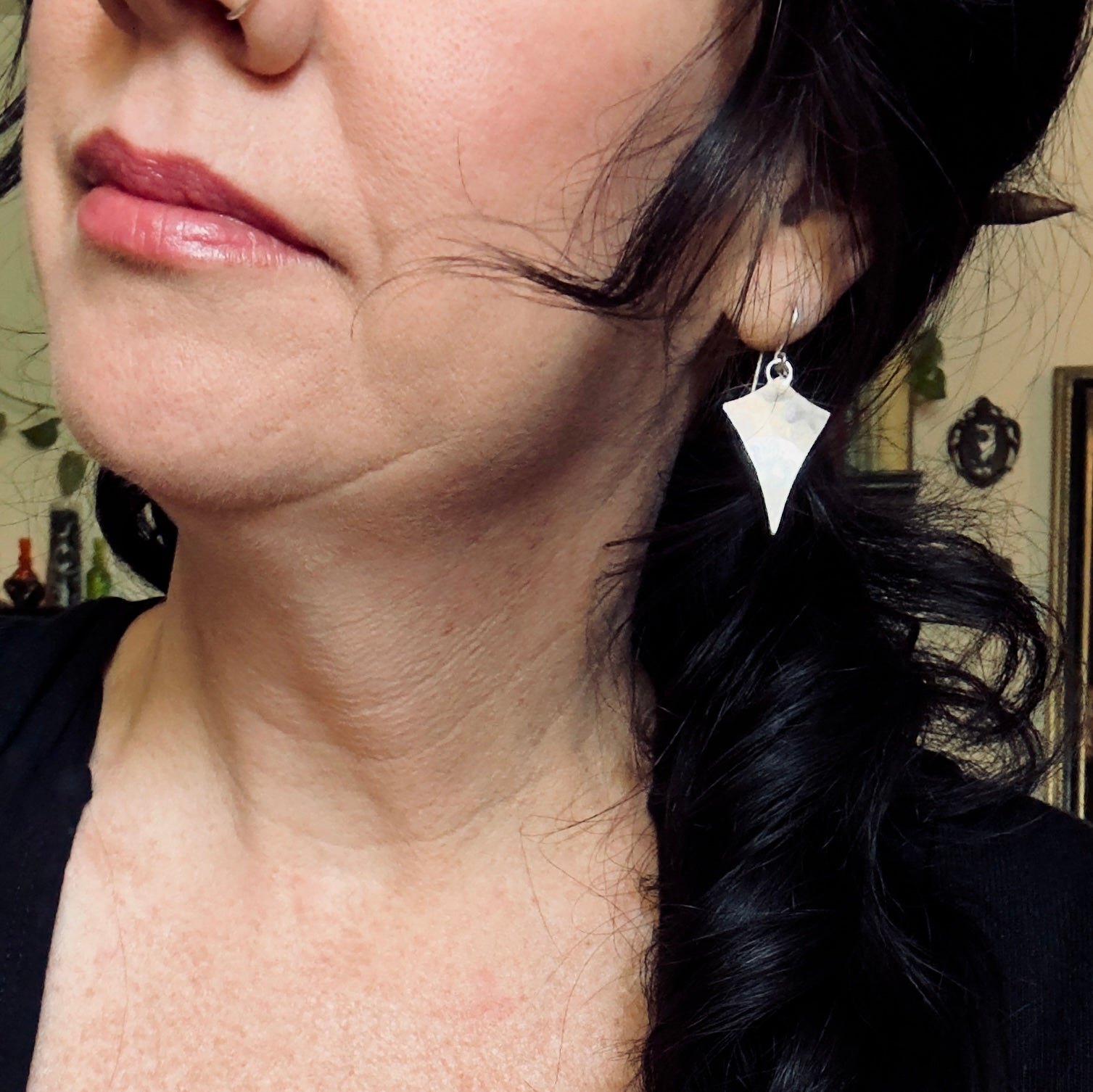 photo of a woman wearing hammered texture star earrings