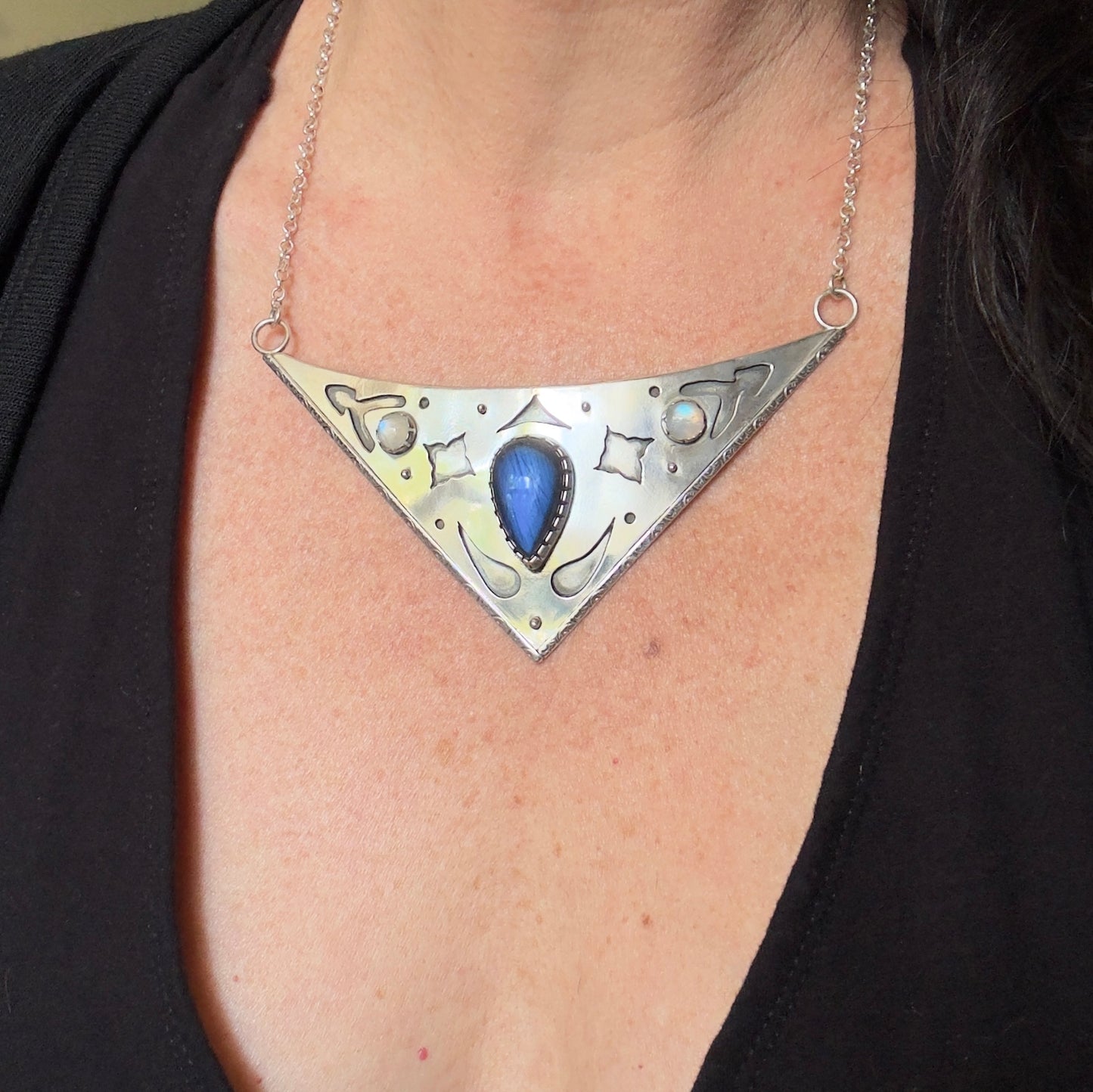 photo wearing an ornate collar necklace with labradorite and moonstone