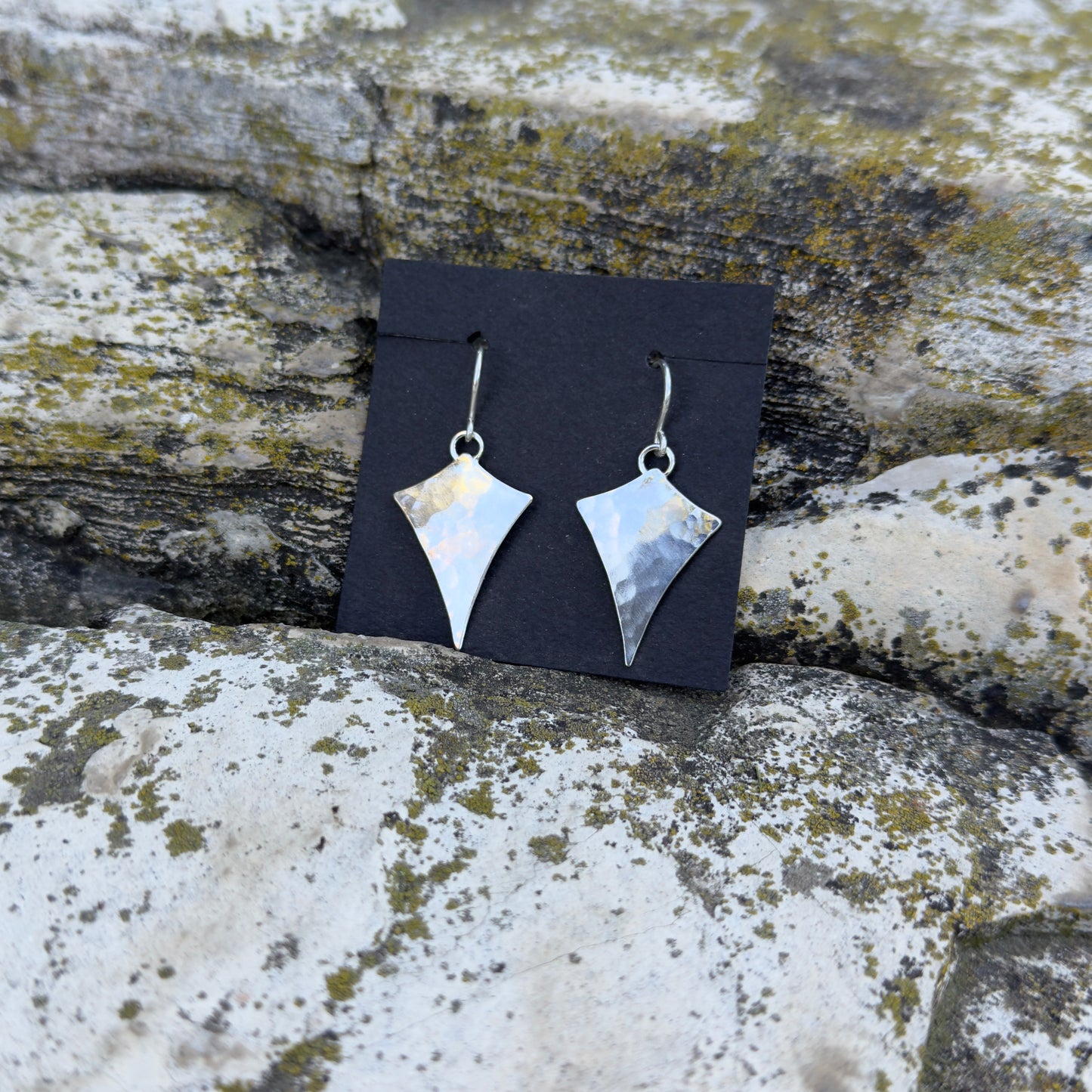 photo of star inspired silver earrings with hammered texture 