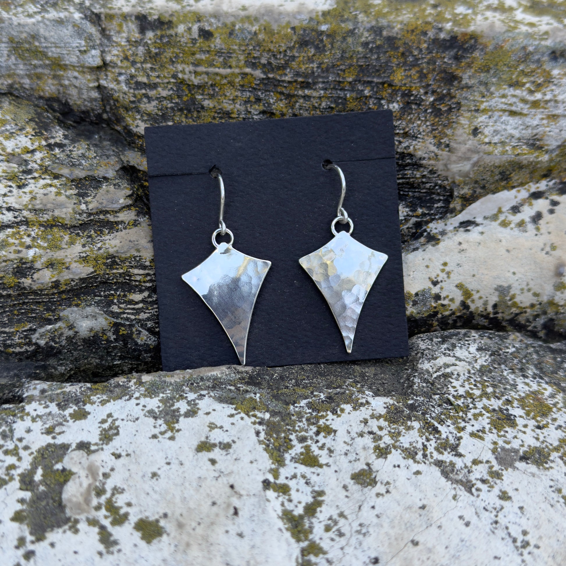 photo of hammered texture star inspired silver earrings