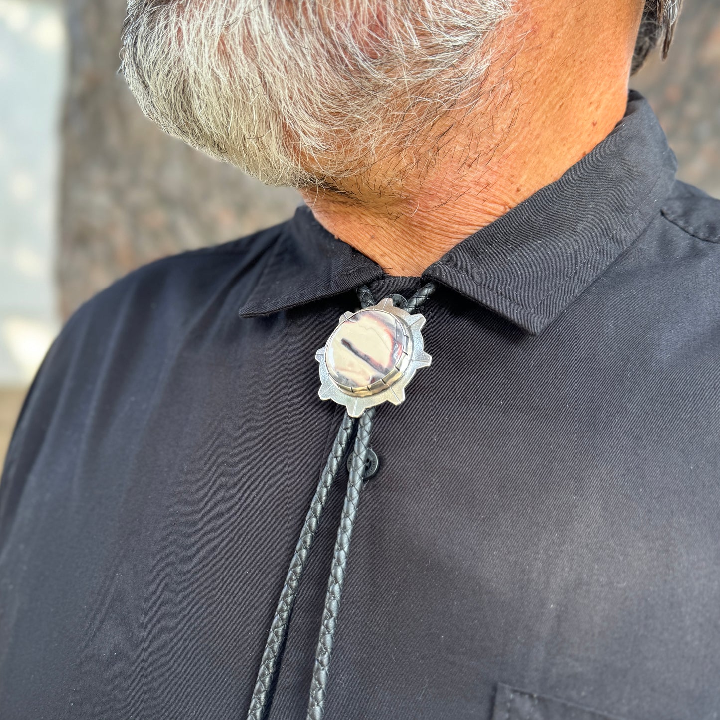 photo of a man's chest wearing unique silver sci-fi jasper bolo tie