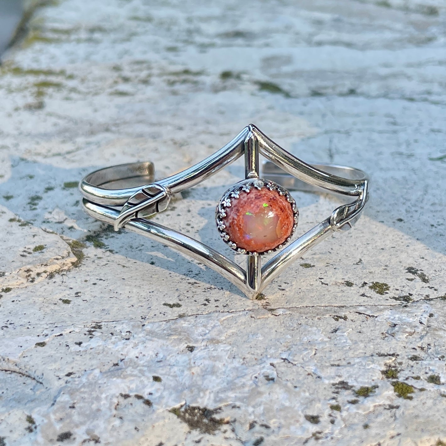 photo of a orange sparkling cantera opal and silver cuff bracelet with leaves