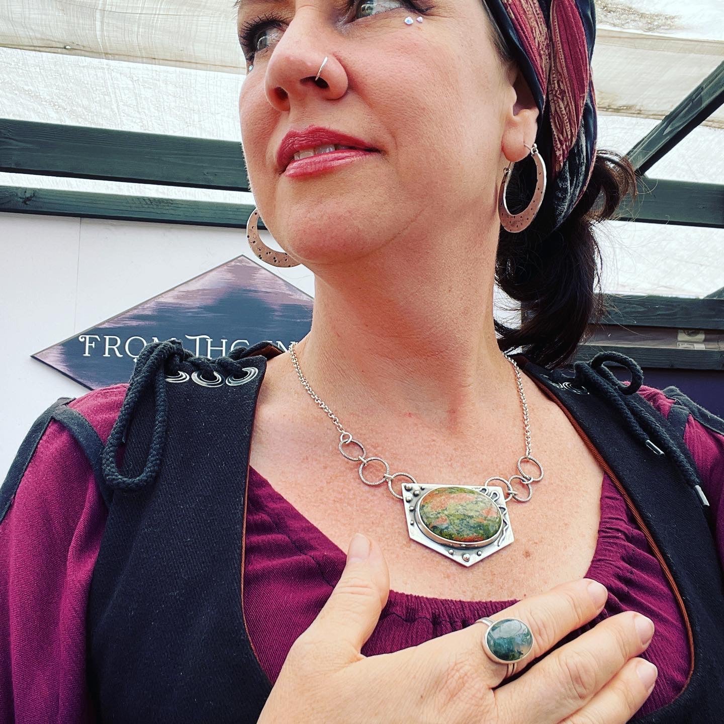 photo of a woman wearing unakite jasper necklace with a snake and spheres 