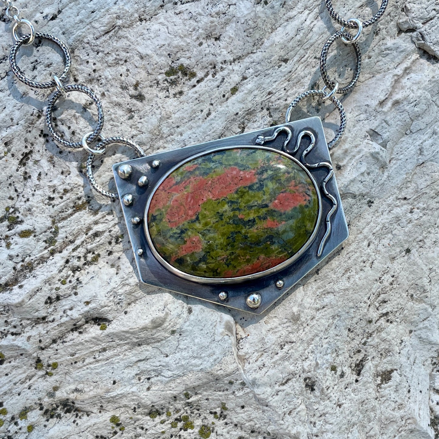 a photo of a silver  unakite jasper necklace featuring a snake