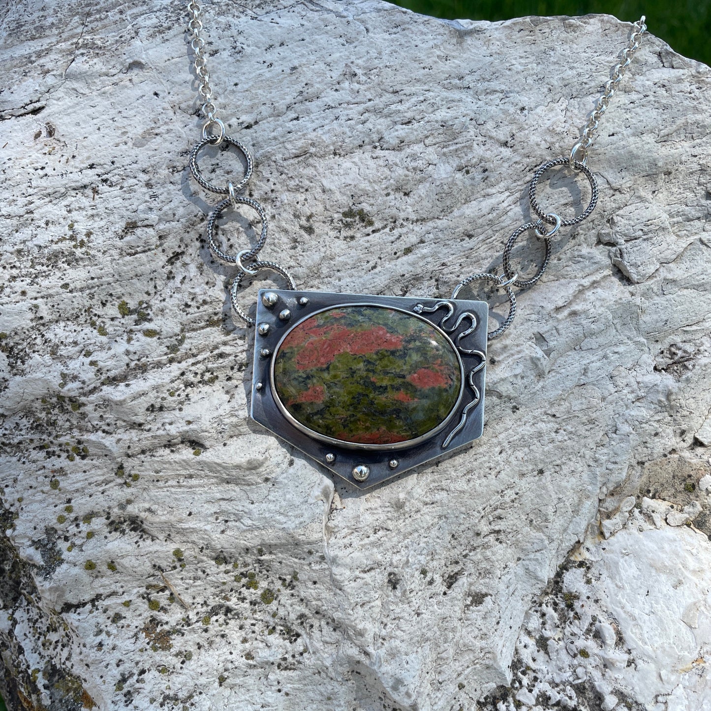 a photo of a silver  unakite jasper necklace featuring a snake